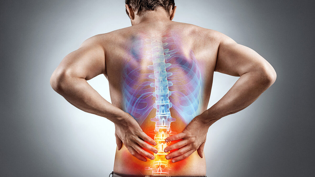 Lower back pain. Man holding his back in pain. Medical concept.